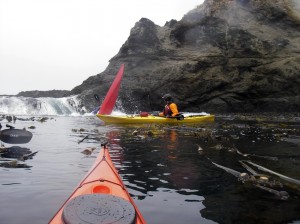 Red kayak with stern deep in the water.