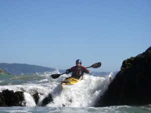 Sea Kayaker paddling a pour-over.