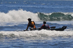 Kayaker and instructor in the surf.