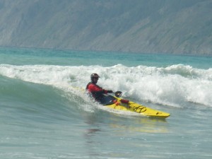 Roger Schumann surfing in his sea kayak